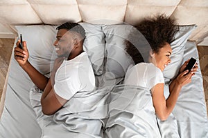 Cheating Black Husband And Wife Using Smartphones Lying In Bedroom