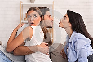 Cheating Boyfriend Kissing Girl Hugging His Girlfriend On Couch Indoor