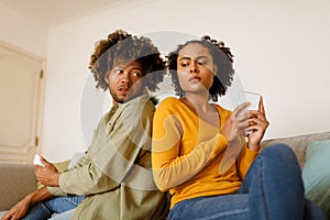 Cheating Couple Peeking At Cellphones Texting And Suspecting Unfaithfulness Indoor photo