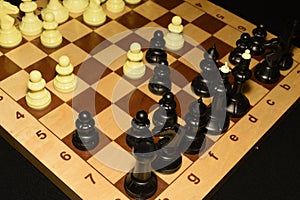 Chechered board with black chessmen for sport backdrop