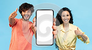 Check This App. Joyful Arab Man And Woman Holding Big Blank Cellphone