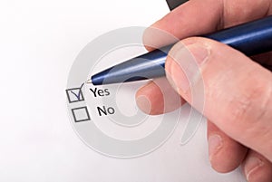 Decision-Making: Close-Up of Hand Checking Yes on Checkboxes photo