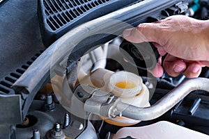 Check brake fluid,Hand open a tank for car maintenance