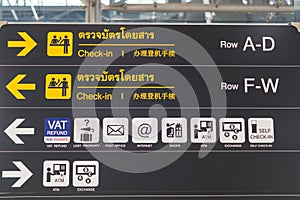 Check-in counter signs at departure terminal in international airport