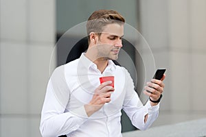 Check emails. Man drinks coffee checking emails in morning urban background. Strat great day. Businessman relaxing with photo