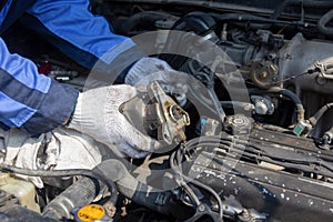 Check engine ignition system and change ignition coil. Car care service..Replacing ignition coil and spark plugs..Car mechanic
