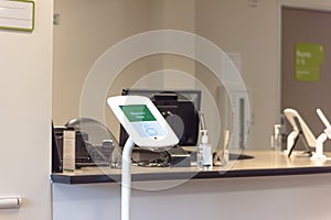 Check-in kiosk tablet at front desk of diagnostic testing