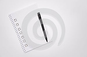 Check list. Square items are empty and checked with a tick. Squared notebook with black pen on a white background. Record ideas,