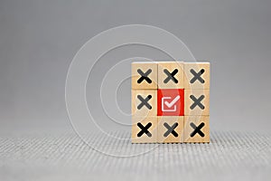 Check mark with cross symbol on cube wooden toy block stack for true or false changing mindset or way of adapting to change