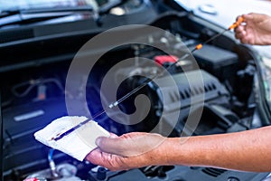 Check the oil level in car engine. Mechanic checking car engine or vehicle. Check and maintenance car with yourself