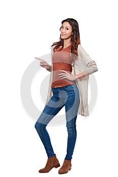 Check this out. Portrait of a confident young woman pointing at blank copyspace in studio.