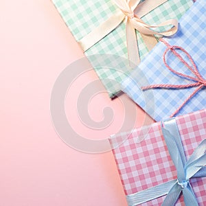 Check pattern colorful gift boxes on pink background