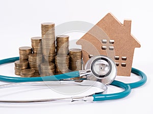 Check up house and investment concept. Stethoscope with miniature house and money