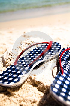 Checked flip-flops on the beach photo