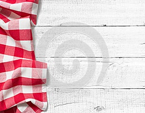 Checked picnic tablecloth on white wood table photo