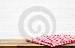 Checked tablecloth on wood with blur white brick wall kitchen background