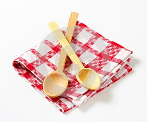 Checked tea towel and wooden spoons