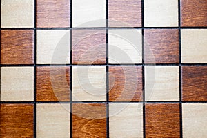 Checkerboard, chessboard detail - top view squares, wooden background