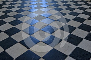 Checkerboard pattern on a stone floor.
