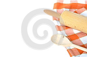 Checkered dishcloth, wooden rolling pin and spoon isolated on white