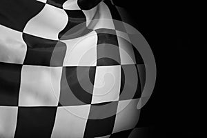 Checkered finish flag on black background, closeup