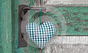 Checkered green heart shape hanging on door handle for wedding,