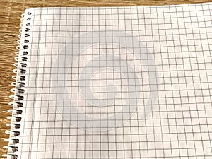 Checkered notebook with spiral. An open notepad for notes. Soft focus. Copy space. Blank blank page for your text