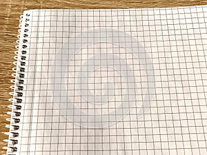 Checkered notebook with spiral. An open notepad for notes. Soft focus. Copy space. Blank blank page for your text
