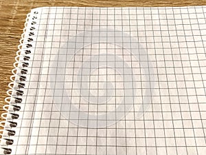 Checkered notebook with spiral. An open notepad for notes. Soft focus. Copy space. Blank blank page for your text
