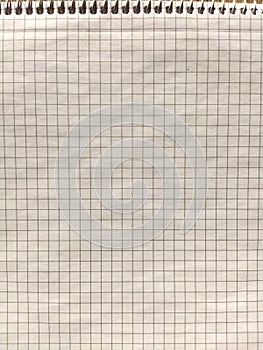 Checkered notebook with spiral. An open notepad for notes. Soft focus. Copy space. Blank blank page for your text