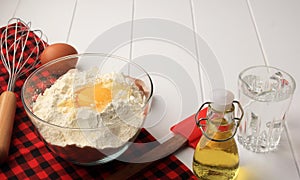 Checkered Pattern for Baking Background with Basic Baking Utensil and Ingredients. Egg, Ballon Whisk, Flour, Oil, and Spatula on