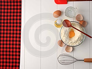 Checkered Pattern for Baking Background with Basic Baking Utensil and Ingredients. Egg, Ballon Whisk, Flour, Oil, and Spatula on