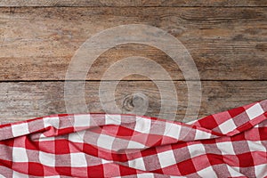 Checkered picnic blanket on wooden background