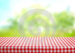 Checkered picnic red table cloth table on natural background