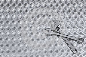 Checkerplate and wrenches background photo