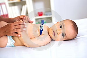 Checking the body temperature of a baby
