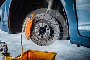 Checking car brake system for repair at car garage