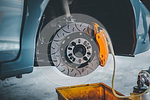 Checking car brake system for repair at car garage