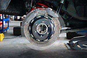 Checking car brake system for repair at car garage