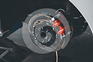 Checking car brake system for repair at car garage