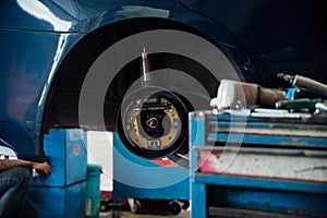 Checking a car suspension for repair at car garage