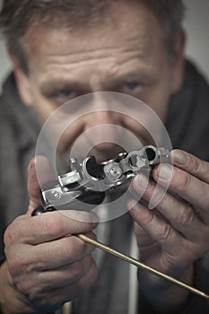 Checking, cleaning and loading of small derringer .38 special handgun by man