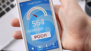 Checking credit score on smartphone using application. The result is POOR