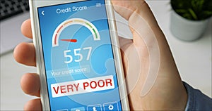 Checking credit score on smartphone using application. The result is VERY POOR