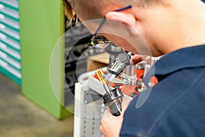 Checking the dimensions of the cutting tool with a caliper for metalworking CNC milling and turning machines.