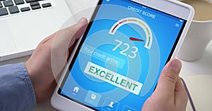 Checking excellent credit score on digital tablet