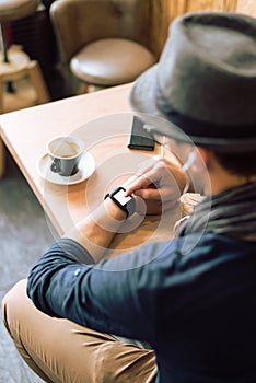 Checking his smartwatch