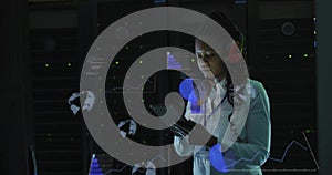 Checking LEDs, tech holding tablet, checking HUD in datacenter, white shirt, red headset lanyard