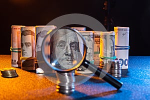 Checking money for falsity. Examining money through a magnifying glass. Checking money photo