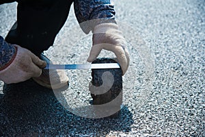Checking the quality of asphalt by taking samples and measuring the thickness of asphalt. Repair of roads